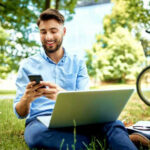 English teacher using an AI essay grader happily outside